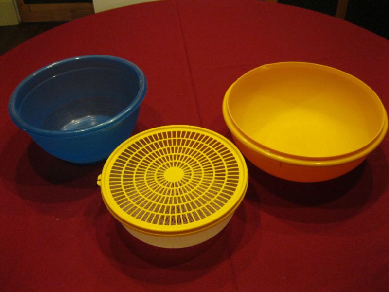 lot of plastic tupperware serving bowls colander  