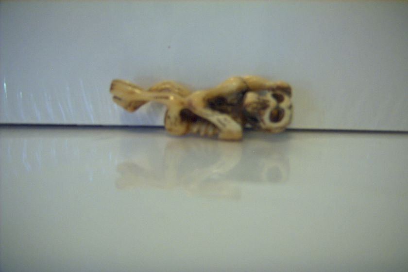 carved bone light skeleton pendant  