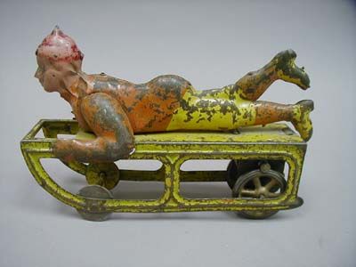 VINTAGE GERMAN TIN TOY BOY SLEDDING FRICTION DRIVE  